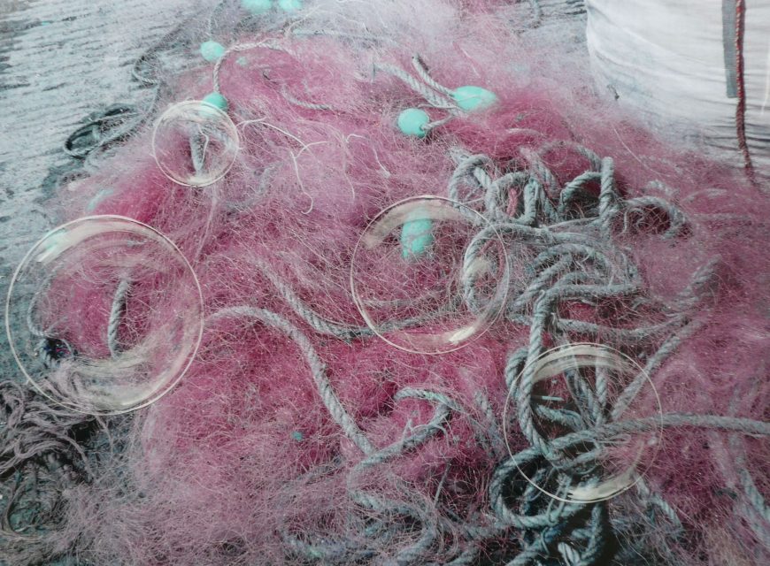 4 transparent moons on mess of fishing nets. 70 x 50 . Mixed media on photo
