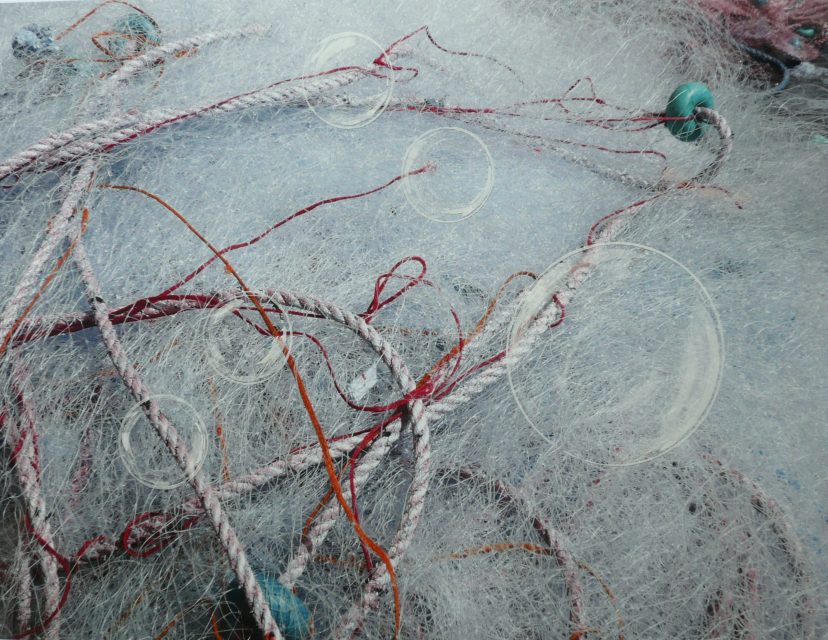 5 transparent moons on mess of fishing nets. 70 x 50 . Mixed media on photo
